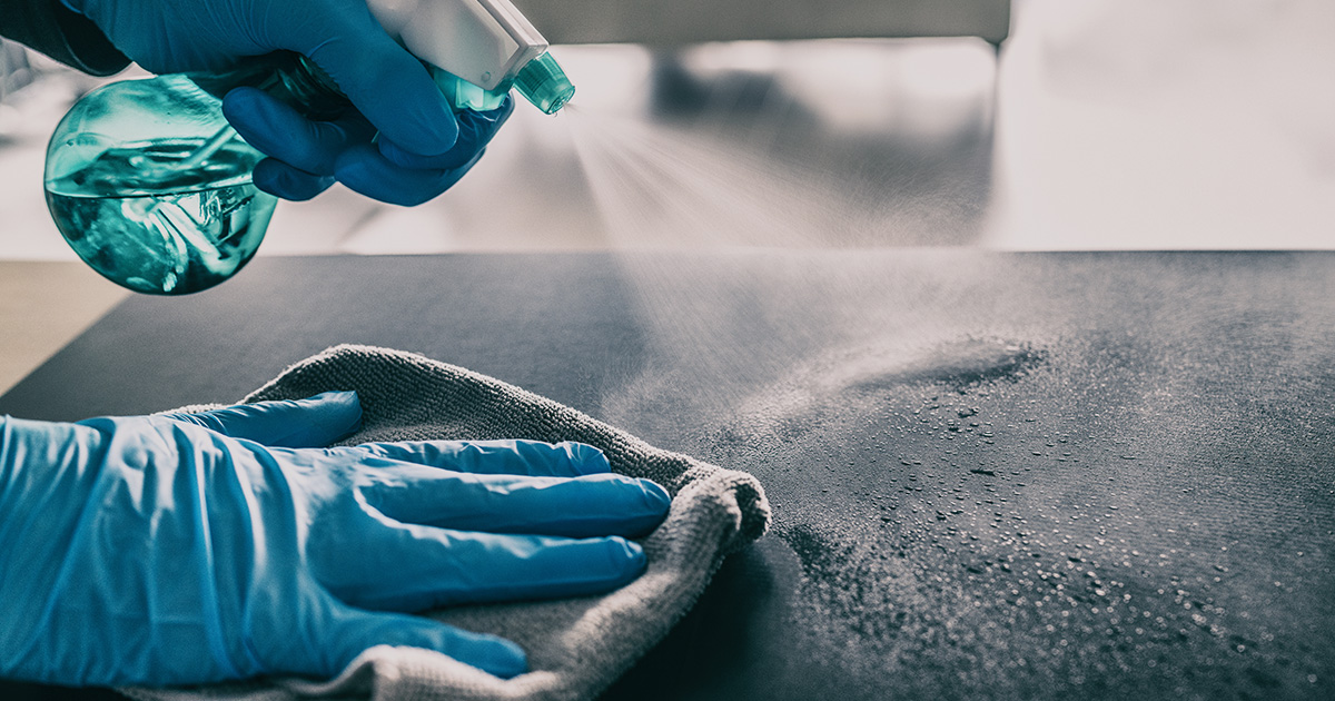 Grooming table being sprayed with cleaning fluid