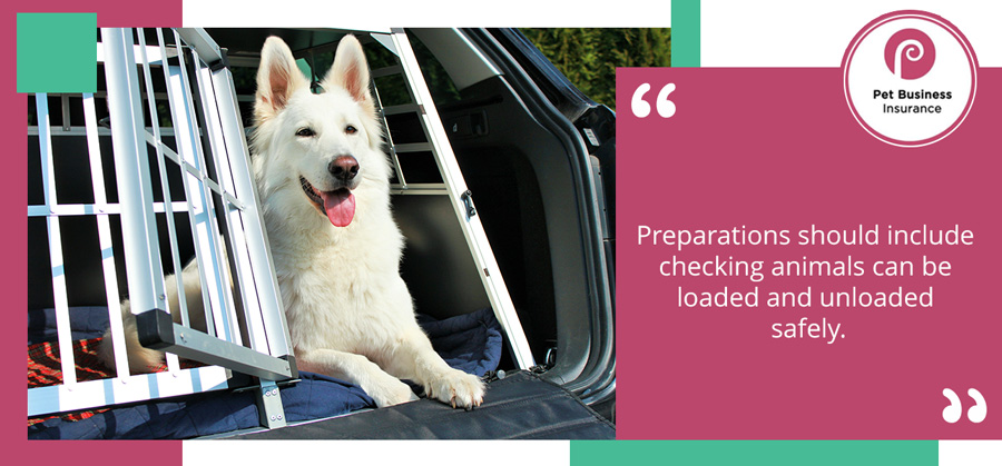 Large dog resting in an open carrier in the back of a vehicle