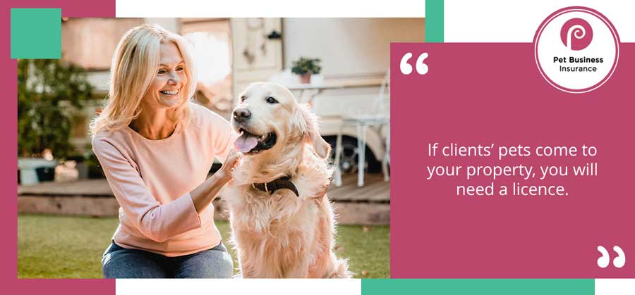 Pet sitter with dog in back garden of client’s home