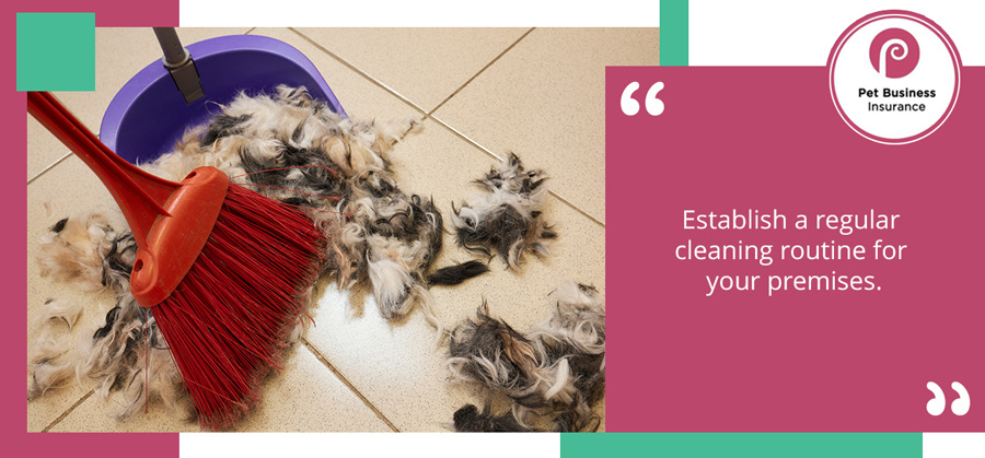 Dustpan and brush being used to clean up dog fur clippings